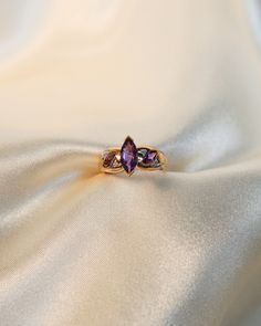 * Ring Material: Amethyst, Diamond, 10K Yellow Gold * Ring Dimensions: 11.7x17MM Top Design, 4.8MM Tapering Band * Size: 7 * Stone Weight & sizes: Amethyst - 1.20ct, Diamond-0.04ct * Overall weight: 3.4g Elegant Multi-stone Amethyst Promise Ring, Heirloom Three Stone Marquise Ring, Heirloom Amethyst Ring With Accent Stones, Heirloom Amethyst Rings With Gemstone Accents, Elegant Purple Multi-stone Birthstone Ring, Heirloom Multi-stone Amethyst Ring, Marquise Amethyst Jewelry With Accent Stones, Amethyst Open Ring With Gemstone Accents For Anniversary, Elegant Multi-stone Amethyst Birthstone Ring