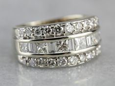 "This diamond cocktail band is utterly lovely! This vintage ring is immaculate, crafted of highly polished white gold and hand inlaid with glittering diamonds! Square, round and baguette stones provide three stacked rows of sparkling luxury! This ring lays comfortable on the finger, a dynamic statement that is easy enough to wear, and could even double as a wedding piece! Metal: 14K White Gold Gem: 33 Diamonds totaling 1.98 Carats, G in Color, SI in Clarity Width of Band: 10.1 mm Height off Fing Stacking Bands, Diamond Glitter, Ring Stacking, Anniversary Bands, Vintage Ring, Wide Bands, Statement Ring, White Gold Diamonds, Diamond White