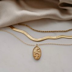 a gold necklace with the word love written on it