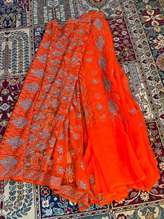 Beautiful orange saree with blue thread chikankaari work by artisans in lucknow India! More colors available Orange Embroidered Georgette Sharara, Embroidered Orange Georgette Sharara, Orange Chikankari Embroidery Sharara For Festivals, Traditional Orange Chanderi Lehenga, Orange Traditional Wear With Resham Embroidery For Festive Occasions, Orange Traditional Wear With Zari Work For Navratri, Orange Chanderi Traditional Wear For Navratri, Festive Orange Traditional Wear With Resham Embroidery, Orange Embroidered Traditional Wear For Festive Occasions