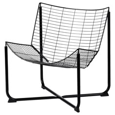 a black and white photo of a wire chair