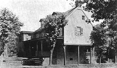 an old black and white photo of a house