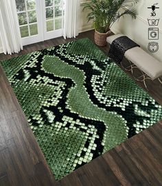 a green area rug with black and white designs on the floor next to a window