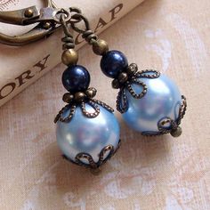 Bronze and Blue Swarovski Pearl Earrings Art by CloudCapJewelry, $15.25 Handmade Blue Dangle Pearl Earrings, Adjustable Blue Pearl Drop Jewelry, Light Blue Metal Earrings As A Gift, Blue Pearl Jewelry For Jewelry Making, Light Blue Metal Earrings For Gift, Elegant Light Blue Pearl Jewelry, Light Blue Round Bead Earrings For Gift, Light Blue Pearl Jewelry For Gift, Blue Pearl Dangle Earrings