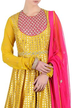 Yellow kalidar anarkali with placement sequin work and all-over foil print. Comes with embellished  pink tassel dupatta and churidar.
Components: 3 
Neckline: Round 
Sleeve Length: Full
Embroidered, Printed
Tassel detail 
Churidar sleeves  
 - Aza Fashions Gold Anarkali Salwar Kameez In Georgette, Gold Maxi Length Salwar Kameez With Dupatta, Fitted Gold Anarkali Set With Mirror Work, Gold Fitted Anarkali Set With Mirror Work, Designer Fitted Anarkali Set With Mirror Work, Gold Anarkali Set With Mirror Work For Eid, Fitted Anarkali Set With Mirror Work For Designer Wear, Gold Anarkali Set With Mirror Work For Diwali, Gold Anarkali Set With Mirror Work For Navratri