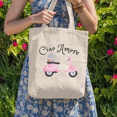 "This sweet Ciao Amore Italy cotton canvas tote makes a perfect gift or gift bag for Italian honeymooners, bridesmaids, or wedding guests; or any one who is dreaming of la dolce vita in Italy.💞 It can be reused as a stylish and trendy book bag, grocery tote, or beach bag. Not quite right? Check out all of our totes, mugs, apparel, and much more, or reach out to me for a custom design! 😊 🌟Enjoy FREE SHIPPING IN THE U.S. ON ORDERS OF $35 OR MORE - *International orders, including Canada do not qualify for Etsy's Free Shipping Guarantee. Therefor, shipping charges will be added at checkout for any order outside the U.S.* Thank you for supporting our small, veteran owned business ‼️Production and shipping times could be longer during the holidays, especially October thru December. Please co Italy Welcome Bag, Embroidered Cotton Bag For Vacation, Embroidered Cotton Vacation Bag, Summer On-the-go Canvas Tote Bag, Destination Wedding Gift Bags, Destination Wedding Gifts, Map Tote Bag, Wedding Gift Bags, Grocery Tote