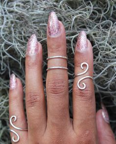 "This listing is for one (1) unique and eye-catching statement ring. The Silver Coiled Midi Ring can be ordered in any normal ring size or midi ring size. Your choice of Silver Plate or Sterling Silver wire is hand shaped in a \"S\" formation, and looks great alone and paired with other rings or alone. Due to the open shape, the ring is slightly adjustable, and great to give as a gift! Specify ring sizes during checkout: An unspecified order will revive a most midi ring size 3/4 Nickel free." Modern Twist Adjustable Midi Rings As Gift, Adjustable Midi Rings With A Modern Twist For Gifts, Whimsical Adjustable Rings, Whimsical Adjustable Ring, Whimsical Adjustable Jewelry Ring, Whimsical Adjustable Ring Jewelry, Adjustable Whimsical Ring, Adjustable Silver Spiral Midi Rings, Adjustable Spiral Silver Midi Rings