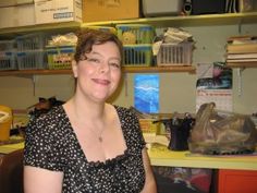 a woman sitting at a desk in an office