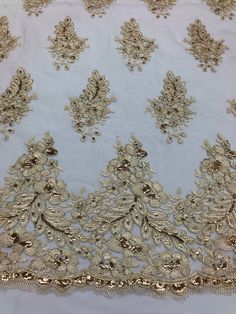 an embroidered fabric with gold thread and sequins