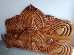 a wooden headboard with intricate carvings on it