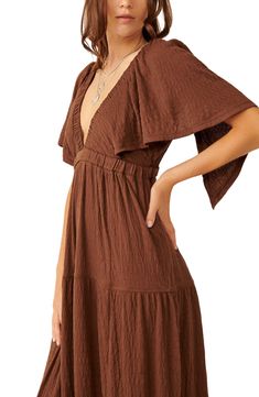 Easy and enchanting, this breezy plunge-neck maxi features fluttering sleeves and a flouncy tiered skirt. 57" length (size Medium) Plunge neck Elbow-length sleeves 65% polyester, 34% viscose, 1% elastane Machine wash, tumble dry Imported