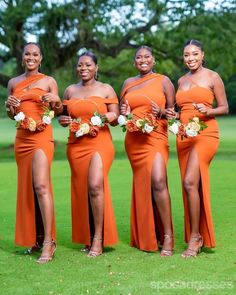 four women in orange dresses posing for the camera