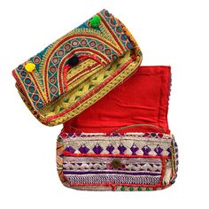 Venya Clutch Vintage banjara clutch is a one of a kind bag crafted from Indian fabric, and embellished with mirror, embroidery, metallic thread or pom-poms. Each one a true work of art. Your bag will be similar to those shown here, but remember, each one is 100% unique and will surprise you with its chic charm. Lined. Magnetic closure. Dimensions: Length 11″ – Width 2.25″ – Height 6.75″ Bohemian Beaded Clutch For Festivals, Traditional Multicolor Beaded Clutch, Bohemian Beaded Festival Clutch, Bohemian Festival Party Clutch, Festive Multicolor Clutch, Bohemian Party Clutch For Festivals, Bohemian Clutch For Festivals And Parties, Bohemian Clutch For Parties And Festivals, Festival Multicolor Embroidery Handwork Clutch