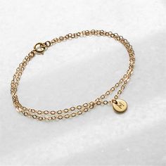 Our Double Chain Bracelet comes in silver, rose or gold chain options. Two sparkling chains for a minimal and chic look for everyday. Adorned with a tiny initial disc for that extra special touch. Makes the perfect gift too! D E T A I L S -Two layers of dainty link chain -Tiny 6mm initial disc. -High quality 14kt gold filled or sterling silver - not plated. LENGTH - Please select from the drop down selection. - Fits most sizing: 6.0 inches extra small 6.5 inches small 7.0 inches medium 7.5 inche Double Chain Bracelet, Block Font, Layered Bracelet, Jewelry Dainty, Personalized Bracelet, Dainty Bracelet, Initial Bracelet, Double Chain, Dainty Bracelets