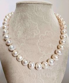 Sixteen (16") inch fine quality, color and luster pearl necklace, remarkably large, almost completely round shape, symbol of timeless elegance with a "royal" look,  36 pearls total, measuring 11.20mm to 12.30mm in size AAA-grade freshwater pearls. Matched in color and quality from premium hank, smooth surface,  Hand knotted with detachable large natural freshwater baroque pearl drop of unusual shape, nice round bulbous body with a trailing tip, measuring 19.60mm x 15.8mm, fine color and luster G Baroque Pearl Necklace For Formal Occasions, Baroque Pearl Necklace For Anniversary, Luxury White Pearl Necklace With Gemstone Beads, High Luster Baroque Pearl Necklace For Formal Occasions, Formal Baroque Pearl Necklace With Round Beads, Formal Baroque Pearl Necklace, White Round Pearl Necklace, Luxury Refined Round Pearl Necklace, Luxury Pearl White Pearl Necklace With Polished Beads