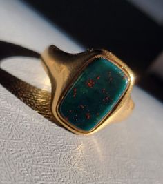 Antique Victorian Era 18K Gold Bloodstone Signet Ring. 18K gold antique bloodstone ring from the 1800s. Beautiful condition considering its age! Size 5.5- can be resized by your local jeweler. Bloodstone Engagement Ring, Vintage Men Rings, Antique Gold Emerald Cabochon Ring, Antique Gold Signet Ring With Gemstone, Vintage Gold Emerald Cabochon Ring, Heirloom Gold Turquoise Gemstone Ring, Victorian Gold Signet Ring With Gemstone, Vintage Yellow Gold Turquoise Ring For Formal Occasions, Heirloom Gold Emerald Cabochon Ring