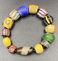 Very old antique beautiful African glass beads bracelet Artisan Beaded Glass Bracelets, Artisan Glass Beaded Bracelets, Vintage Glass Beads With Large Beads, Vintage Glass Oval Beads, Spiritual Hand-strung Glass Bracelets, Antique Style Colorful Beads For Gift, Vintage Multicolor Stretch Bracelet With Round Beads, Vintage Handmade Glass Bracelets, Glass Beaded Bracelets For Jewelry Making