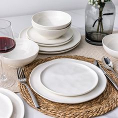 a place setting with white plates and silverware