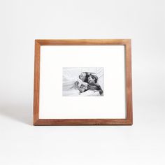 a black and white photo in a wooden frame