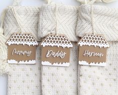 three tags that say mommy's and daddy's hanging from the back of some blankets