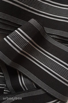 the black and white striped fabric is folded on top of each other