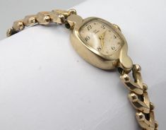 Vintage Elgin Deluxe ladies wristwatch. Elegant design in polished gold tone finish. Spring wound mechanical movement. Linked chain bracelet style band with gold tone and stainless-steel elastic portion.  Good condition. Mechanically fully serviced and working great. Your watch will be shipped safely in a custom gift box suitable for presentation. Deck Vintage strives on being a source for authentic vintage and historic items in the best condition possible. Any flaws or wear will be visible in photos, any significant or hard to see flaws will be mentioned in description. All watches are cleaned, with all moving parts serviced and fully tested. Feel free to message me for any questions you may have, I'm easy to talk to. Although your item will be mindfully packaged, there is always a chance Ladies Bracelet Watch, Presentation Deck, Antique Watch, Ladies Bracelet, Custom Gift Boxes, Antique Watches, Bracelet Style, Mechanical Movement, Women Wrist Watch