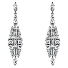 Art Deco Inspired 18ct White Gold 1.75ct Diamond Drop Earrings Elevate your elegance with our stunning 18ct White Gold Diamond Drop Earrings, a masterpiece of craftsmanship and style. These exquisite earrings feature a dazzling display of graduated round brilliant cut diamonds, artfully arranged to frame a captivating core of baguette and tapered baguette cut diamonds. Together, they create a magnificent Deco-style drop that exudes sophistication and timeless beauty. Crafted from luxurious 18ct Luxury Art Deco Round Earrings, Formal Platinum Diamond Earrings Baguette Cut, Formal Baguette Cut Platinum Diamond Earrings, Formal Diamond White Diamond Earrings With Baguette Cut, Diamond White Baguette Cut Diamond Earrings For Formal, Diamond White Baguette Cut Diamond Earrings For Formal Occasions, Baguette Cut Diamond White Earrings For Formal Occasions, Platinum Baguette Diamond Earrings For Wedding, Wedding Platinum Earrings With Baguette Diamonds