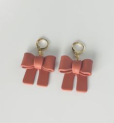 Handmade polymer clay bows in the color terracotta with a gold plated huggie hoop Chic Small Hoop Pink Jewelry, Chic Small Pink Hoop Earrings, Chic Small Pink Hoop Jewelry, Trendy Rose Gold Drop Earrings, Trendy Handmade Rose Gold Jewelry, Handmade Pink Hoop Earrings Gift, Brown Single Hoop Earring As Gift, Trendy Round Jewelry As Gift, Trendy Round Jewelry For Gift