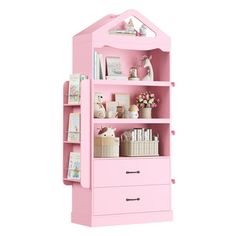 a pink bookcase with lots of books on it's sides and drawers underneath