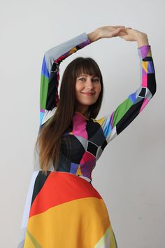 CITRINE DRESS  The original abstract print design on the dress is created by a professional artist. Colourful abstract print dress with geometrical elements, with long sleeves. Be unique. Be outstanding. Be authentic. Bright and lively colors have the power to uplift mood and instill a sense of joy. Wearing a vibrant color dress can evoke feelings of happiness and positivity, brightening not only the wearer's day but also those around her. The dress showcases an original abstract print design, where dynamic geometrical elements dance across the fabric in a symphony of colors. Bold triangles, squares, and circles intertwine, creating a visual feast for the eyes. Each element is meticulously placed to evoke a sense of movement and rhythm.  * 95% polyester, 5% elastane (fabric composition may Citrine Dress, Bold Pattern Dress, Dress Geometric, Abstract Print Dress, Dress Trendy, Colorful Dress, Colourful Abstract, Spring Clothing, Color Abstract