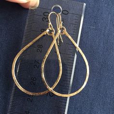 "Everybody will notice these hoops on you because they reflect light in a really beautiful way. These hoops sparkle and are hand shaped, hammered, and polished to a glittering finish. The hammering gives the surface of the sterling wire a glittering effect. The entire earring is apprx 1 7/8\". The hoop length alone is apprx 1.5\". These are shown with Gold Filled french ball earwires. I can attach any stone or stones in my vast treasure trove that will fit, dangling from a chain, so please conta Gold Teardrop Hoop Earrings With Lever Back, Gold Teardrop Hoop Earrings For Anniversary, 14k Gold Filled Teardrop Hoop Earrings For Anniversary, Teardrop 14k Gold Filled Hoop Earrings For Anniversary, 14k Gold Teardrop Hoop Earrings With Lever Back, Handmade Teardrop 14k Gold Hoop Earrings, Hammered Teardrop Earrings For Anniversary, Everyday Gold Teardrop Hoop Earrings, Teardrop 14k Gold Filled Hoop Earrings