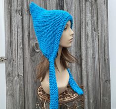 Knit Hat Style: Pixie Hat - a chunky bonnet with a pointed crown and knitted ties, for women, men and teens. Color: This sample hat is shown in Turquoise Blue. Sizes: One size fits average teen or adult head size of 20" to 23" (50.5 cm to 58 cm). Fiber Content: 100% acrylic Characteristics: Whimsical, chunky, very soft, warm and cozy. Care Instructions: Hand wash, dry flat. Every item from Pixiebell is handmade and knit or crocheted to order, unless otherwise stated in title of the item as "read Adjustable Knitted Green Bonnet, Blue Winter Bonnet Hat, Playful Knitted Bonnet, One Size, Blue Hand Knitted Bonnet, Multicolor One-size Bonnet, Mens Hat, Chunky Knit Hat, Womens Hat, Pixie Hat