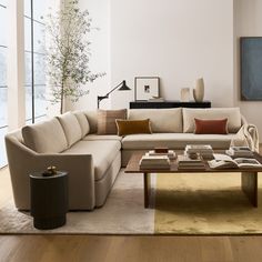 a living room filled with lots of furniture and decor on top of a hard wood floor