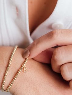 Make your stack personal with an Initial Charm! Wear your own initial, your children's, or a loved one's for a sentimental touch — or gift the heartwarming piece to someone you love. Designed with durability in mind, our gold-fill beads and charms are secured on extra-strength stretch cord to withstand your busy life and maintain their shine. Whether you dress them up, dress them down, or pile them on, you’ll truly never take them off. Classic Personalized Beaded Bracelets As Gift, Classic Personalized Beaded Bracelets For Gifts, Classic Initials Bracelet, Perfect As Gift, Classic Personalized Beaded Bracelets For Everyday, Classic Hypoallergenic Bracelets As Personalized Gift, Classic Hypoallergenic Bracelets For Personalized Gifts, Classic Adjustable Bracelets With Heart Charm, Classic Adjustable Bracelet With Heart Charm, Minimalist Yellow Gold Stretch Bracelet As Gift