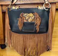 Reflecting western style, this western bag is the perfect accessory for those who love cowboy and rodeo themes. An elegant and stylish crossbody bag made of high quality leather material. Ideal for daily use, this bag is both practical and fashionable.  Ideal for festivals and outdoor events, this bag is made of durable black and brown leather. It offers comfortable use with its lightweight and useful design. It was also designed for those who embrace both Native American culture and Bohemian style. An elegant and stylish crossbody bag made of high quality leather material. It stands out with its fringe details and original design. It can be used both as a crossbody bag and as a shoulder bag. This bag is inspired by ethnic patterns and natural materials. It is ideal for those looking for a Bohemian Leather Bag With Concho, Bohemian Brown Bags With Concho, Western Brown Bag With Fringe, Brown Western Bag With Fringe, Western Style Bags For Festivals, Western Brown Bags For Rodeo, Western Style Brown Bags For Rodeo, Brown Rectangular Bag For Rodeo, Rectangular Brown Bag For Rodeo