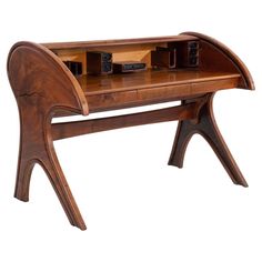 a wooden desk with an unusual shaped top and drawers on the bottom, sitting in front of a white background