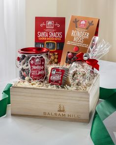 a wooden box filled with assorted treats and candys on top of a table