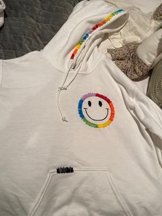 Hand embroidered rainbow smiley face hoodie!! Trendy Hoodie With Embroidered Logo, Rainbow Cotton Sweatshirt For Winter, Trendy Embroidered Hooded Hoodie, Fun Hoodie Sweatshirt With Drawstring Hood, Fun Sweatshirt With Drawstring Hood, Fun Cotton Hoodie, Fun Cotton Hooded Hoodie, Rainbow Casual Winter Hoodie, Casual Winter Rainbow Hoodie