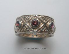 Unique byzantine band ring with ruby red spinels.  This handmade, engraved band is shown in Sterling Silver has a textured surface and overall feel of an antique, medieval ring, inspired by antique jewelry from the Middle Ages Byzantium. It is set with seven 3 mm faceted pinky-red spinels.  Would make a unique Anniversary Ring. If you prefer to make several instalment payments, please contact us regarding our very flexible and interest-free LAYAWAY PLAN. There is a ring in silver as pictured rea Colourful Wedding Ring, Byzantine Wedding, Medieval Wedding Ring, Gemstone Wedding Band, Sterling Silver Stone Rings, Byzantine Ring, Medieval Ring, Byzantine Rings, Ring With Ruby