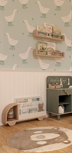 a child's room with bookshelves and toys on the wall, along with a rug