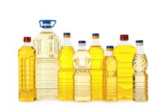 several bottles of oil are lined up against a white background