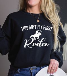 .This aint my first rodeo sweatshirt. ---------------------------------------------------------- Material: 80% ringspun cotton/20% polyester. - Drop shoulder style. - Stylish fit. - Soft cotton faced fabric. - Taped neck. - Ribbed collar, cuffs and hem. - Twin needle stitching. - WRAP Certified Production. Weight: 280 gsm -------------------------------------- Our entire shop here  https://etsy.me/3d9lkzC  This aint my first rodeo sweatshirt, cowgirl shirt, not my first rodeo, howdy yall, Wild West Country shirt, Nashville tee, yee haw shirt,       * please note, this design is created by myself using graphic design software, we use a production partner to help us print and ship to our UK and USA locations...this enables access to the BEST large scale printers in the world, cuts our produc Western Crew Neck Tops With Letter Print, Western Style Crew Neck Top With Letter Print, Western Style Letter Print Crew Neck Tops, Pre-shrunk Tops For Rodeo In Fall, Fall Ranch Crew Neck T-shirt, Not My First Rodeo, My First Rodeo, First Rodeo, Santa Sweatshirt