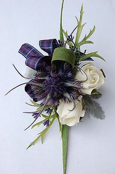 a purple and white boutonniere with flowers on the side is shown in an instagram post