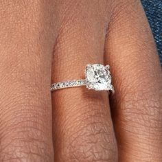 a woman's hand with a diamond ring on it