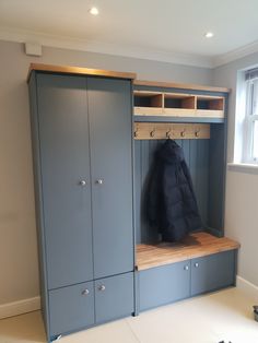 an empty room with a coat rack and lockers