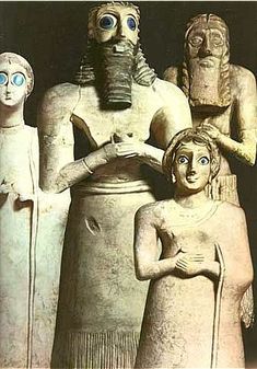 an image of some statues that are in the shape of men and women with faces painted on them