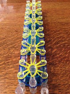 some plastic beads sitting on top of a wooden table