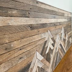 a wood paneled wall with wooden arrows painted on it