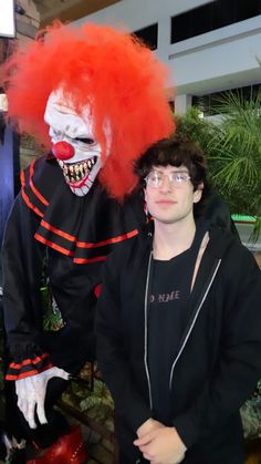 two people dressed up as clowns posing for the camera