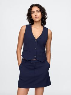 Smooth woven cropped vest.  V-neck.  Sleeveless.  Button front.  Welt pockets.  Fit: Close to the body.  Cropped, hits at the waist.  Models wearing Gap Cropped Vest, Welt Pockets, New Woman, The Body, Welt Pocket, Old Navy, Gap, Navy Blue, Models